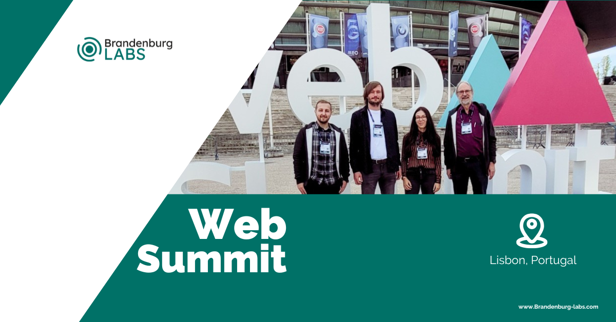 Four People standing in front of the We summit entrance